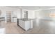 Open kitchen features a center island with sink, stainless steel appliances, and an adjacent open living area at 5053 E Umber Rd, San Tan Valley, AZ 85143