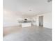 Bright open-concept kitchen has granite countertops, stainless appliances, and modern cabinetry adjacent to the living room at 5053 E Umber Rd, San Tan Valley, AZ 85143