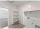 The laundry room features built-in shelving and is next to another room with a window at 5053 E Umber Rd, San Tan Valley, AZ 85143