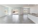 Bright living room with tiled floors, large windows, and seamless access to the backyard through sliding glass doors at 5053 E Umber Rd, San Tan Valley, AZ 85143