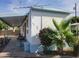 Charming single-story home with carport, palm tree, and beautiful landscaping at 61 W Southern Ave # 63, Mesa, AZ 85210