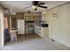 Cozy kitchen featuring essential appliances, cabinets, and flooring at 61 W Southern Ave # 63, Mesa, AZ 85210