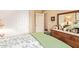 Comfortable bedroom features a bed with floral bedding, a dresser, and a closet at 6482 S Claiborne Ave, Gilbert, AZ 85298
