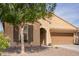 View of the front exterior with desert landscaping, featuring an attached two-car garage and neutral color scheme at 6482 S Claiborne Ave, Gilbert, AZ 85298
