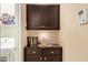 Functional laundry room with upper cabinets and a counter for folding laundry at 6482 S Claiborne Ave, Gilbert, AZ 85298