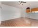 Bedroom with wood floor, a ceiling fan, natural light from a window, and white walls at 6853 S Roosevelt St, Tempe, AZ 85283