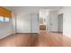 Bedroom with wood floor, natural light, with an open bathroom and mirrored closet at 6853 S Roosevelt St, Tempe, AZ 85283