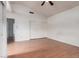 Bedroom with wood floors, a ceiling fan, natural light, and mirrored closet at 6853 S Roosevelt St, Tempe, AZ 85283