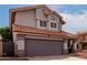 Exterior shot of a two-story home with gray siding, a tile roof and a two-car garage at 6853 S Roosevelt St, Tempe, AZ 85283