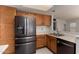 Spacious kitchen featuring stainless steel refrigerator and sink with wood cabinets at 6853 S Roosevelt St, Tempe, AZ 85283