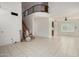 Spacious living area with stairs and in-home elevator, bright tile flooring, and staircase at 6853 S Roosevelt St, Tempe, AZ 85283