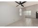 Bright living room features tile flooring, large windows, and a modern ceiling fan at 6853 S Roosevelt St, Tempe, AZ 85283