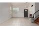 Comfortable living room with bright tile flooring, front door access, and in-home elevator at 6853 S Roosevelt St, Tempe, AZ 85283