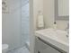 Well-lit bathroom with a modern vanity, a sink, and a walk-in shower at 6945 E Osborn Rd # E, Scottsdale, AZ 85251
