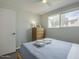 Inviting bedroom with a well-lit window, a cozy bed, and a charming dresser at 6945 E Osborn Rd # E, Scottsdale, AZ 85251