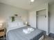 Airy bedroom with a shelf featuring stylish decor, a sliding closet and ceiling fan at 6945 E Osborn Rd # E, Scottsdale, AZ 85251