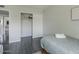 Neutral bedroom featuring a closet with sliding doors and view into another room at 6945 E Osborn Rd # E, Scottsdale, AZ 85251