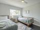 Bright bedroom featuring twin beds with stylish bedding and natural light from the window at 6945 E Osborn Rd # E, Scottsdale, AZ 85251
