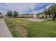 Inviting complex with green lawn, mature trees, and well-maintained common areas at 6945 E Osborn Rd # E, Scottsdale, AZ 85251
