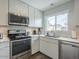 This modern kitchen features stainless steel appliances, white cabinets and quartz countertops at 6945 E Osborn Rd # E, Scottsdale, AZ 85251