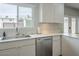 The kitchen includes stainless steel appliances, and quartz countertops with white cabinets at 6945 E Osborn Rd # E, Scottsdale, AZ 85251