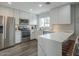 Bright kitchen features white cabinets, stainless steel appliances, a breakfast bar and wood look flooring at 6945 E Osborn Rd # E, Scottsdale, AZ 85251