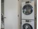 New, stacked, front-load washer and dryer set in a laundry closet at 6945 E Osborn Rd # E, Scottsdale, AZ 85251