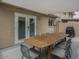Patio boasts outdoor dining set, shade, and seamless access via double doors at 6945 E Osborn Rd # E, Scottsdale, AZ 85251
