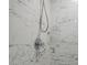 Close-up of a shower featuring marble-patterned tile and a modern shower head at 6945 E Osborn Rd # E, Scottsdale, AZ 85251