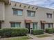 Inviting townhouse with a brick facade, red tile awning, and mature landscaping at 6945 E Osborn Rd # E, Scottsdale, AZ 85251