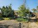 Backyard with greenery, gravel, and partial view of the house at 723 E Moreland St, Phoenix, AZ 85006
