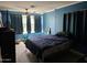 Cozy blue bedroom with natural light, a ceiling fan, and ample space at 723 E Moreland St, Phoenix, AZ 85006