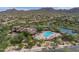 Gorgeous aerial view of the community amenities featuring a sparkling pool, tennis courts and mature landscaping at 7445 E Eagle Crest Dr # 1061, Mesa, AZ 85207
