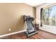 Bedroom features wood floors, neutral walls, window, and a treadmill at 7445 E Eagle Crest Dr # 1061, Mesa, AZ 85207