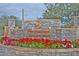 Beautiful stone community entrance sign with colorful flowers and lush landscaping in front at 7445 E Eagle Crest Dr # 1061, Mesa, AZ 85207