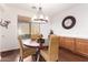 Cozy dining area with a round wooden table, wicker chairs, hardwood flooring, and natural light at 7445 E Eagle Crest Dr # 1061, Mesa, AZ 85207