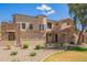 Charming home featuring stone accents, a tiled roof, a landscaped yard, and well manicured desert landscaping at 7445 E Eagle Crest Dr # 1061, Mesa, AZ 85207