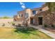 Charming home featuring stone accents, a tiled roof, a landscaped yard, and well manicured desert landscaping at 7445 E Eagle Crest Dr # 1061, Mesa, AZ 85207