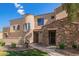 Charming home featuring stone accents, a tiled roof, a landscaped yard, and well manicured desert landscaping at 7445 E Eagle Crest Dr # 1061, Mesa, AZ 85207