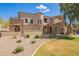 Charming home featuring stone accents, a tiled roof, a landscaped yard, and well manicured desert landscaping at 7445 E Eagle Crest Dr # 1061, Mesa, AZ 85207