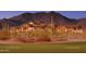 Stunning exterior view of the community clubhouse with mountain views, mature landscaping and golf course at 7445 E Eagle Crest Dr # 1061, Mesa, AZ 85207