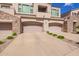 Three car garage, with desert landscaping and neutral paint at 7445 E Eagle Crest Dr # 1061, Mesa, AZ 85207