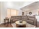 Spacious living room with a stylish sectional sofa, mirrored coffee table and hardwood flooring at 7445 E Eagle Crest Dr # 1061, Mesa, AZ 85207