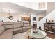 Open-concept living room with a comfortable sectional sofa, hardwood floors, and a view of the kitchen at 7445 E Eagle Crest Dr # 1061, Mesa, AZ 85207