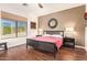 Comfortable bedroom featuring hardwood floors, a ceiling fan, and an exterior view from the window at 7445 E Eagle Crest Dr # 1061, Mesa, AZ 85207