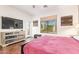Comfortable bedroom with hardwood floors, balcony access, and a large window with an exterior view at 7445 E Eagle Crest Dr # 1061, Mesa, AZ 85207