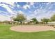 A community playground with swings, picnic tables, and shade structures in a well-kept, grassy park at 7445 E Eagle Crest Dr # 1061, Mesa, AZ 85207