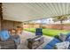 Backyard patio with seating area including fire pit and a well manicured lawn at 7520 E Diamond St, Scottsdale, AZ 85257