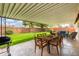 Backyard featuring a covered patio with a dining table and outdoor sofa at 7520 E Diamond St, Scottsdale, AZ 85257