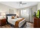 Cozy bedroom featuring a ceiling fan, queen bed, and bright natural lighting at 7520 E Diamond St, Scottsdale, AZ 85257